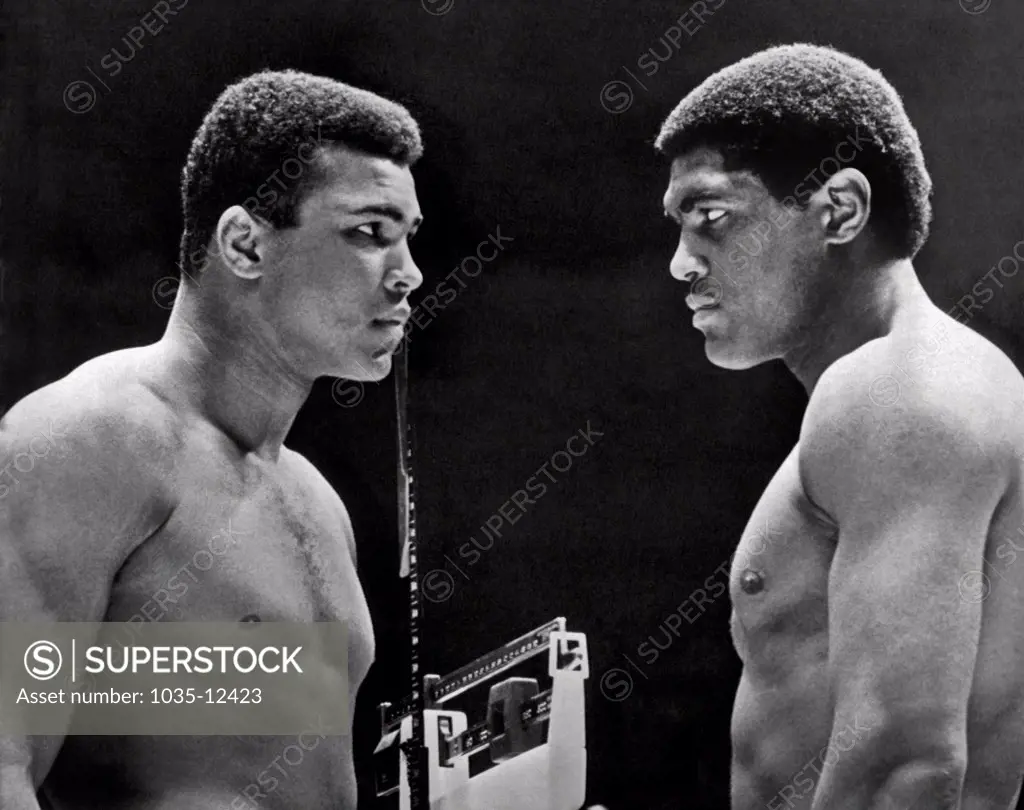 Houston, Texas:   February, 6, 1967. Heavyweight champion Cassius Clay focuses his whammy eye on challenger Ernie Terrell during the weigh in for tonight's title fight.