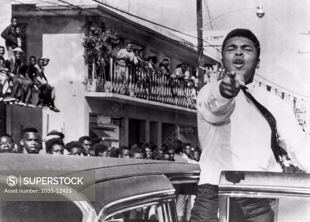 Miami, Florida:  December 14, 1963. Cassius Clay who is training in Miami for his title fight against Sonny Liston, takes part in a pre football game parade.