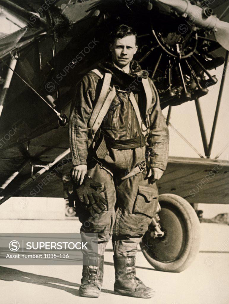 Stock Photo: 1035-136 Portrait of a fighter pilot standing near a military aircraft