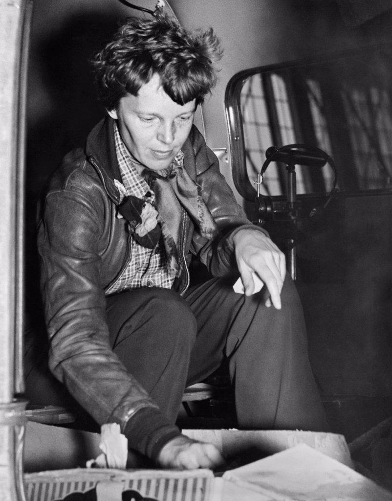 Oakland, California:  March 14, 1937 Aviatrix Amelia Earhart checks her cockpit supplies for her departure to Honolulu on the first leg of her globe circling flight.