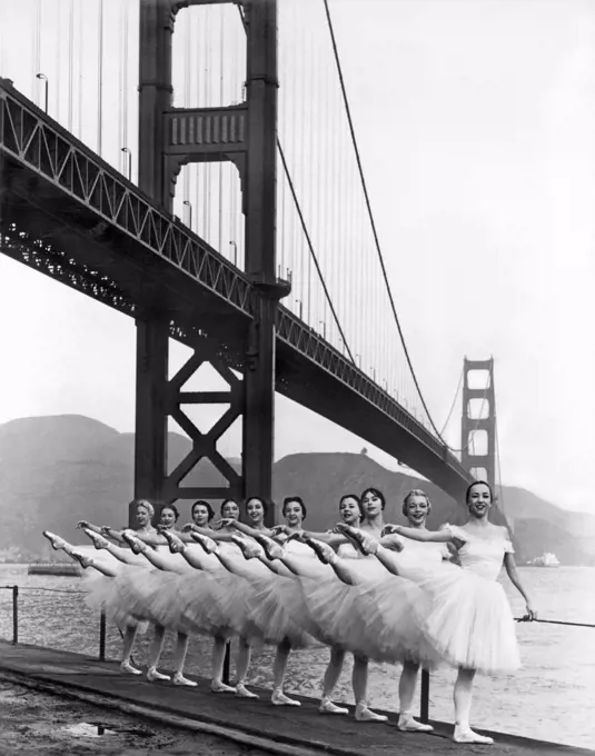 San Francisco, California:   c. 1960. San Francisco Ballet Company under the Golden Gate Bridge at the Fort Point promenade.