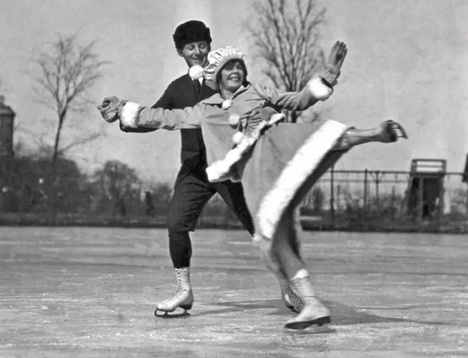 Chicago, Illinois:  c. 1919. A skating pair show off with some nifty moves on skates.