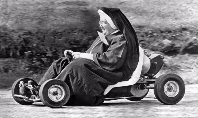 Akron, Ohio: October 10. 1962. Sister John Bosco of the St. Sebastian School  in Akron having fun tooling around a go-kart track.