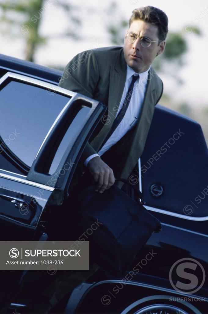 Stock Photo: 1038-236 Businessman stepping out of a car
