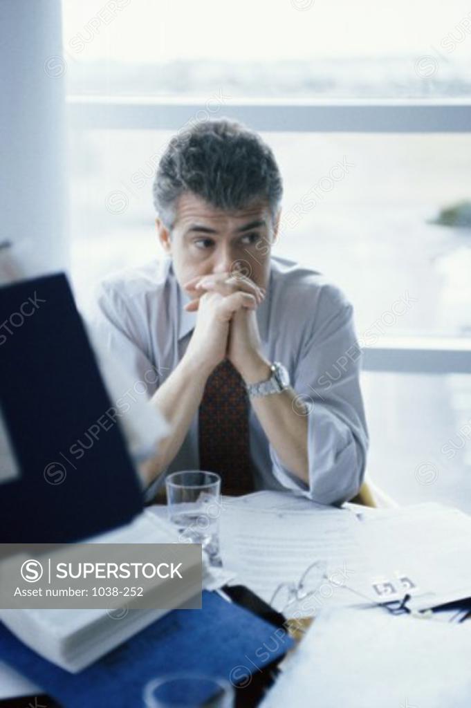 Stock Photo: 1038-252 Businessman sitting with his hands together