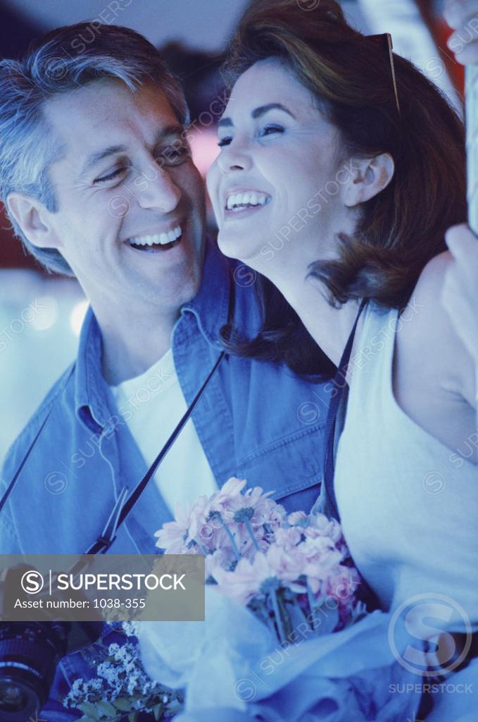 Stock Photo: 1038-355 Mid adult man giving a bouquet of flowers to a mid adult woman