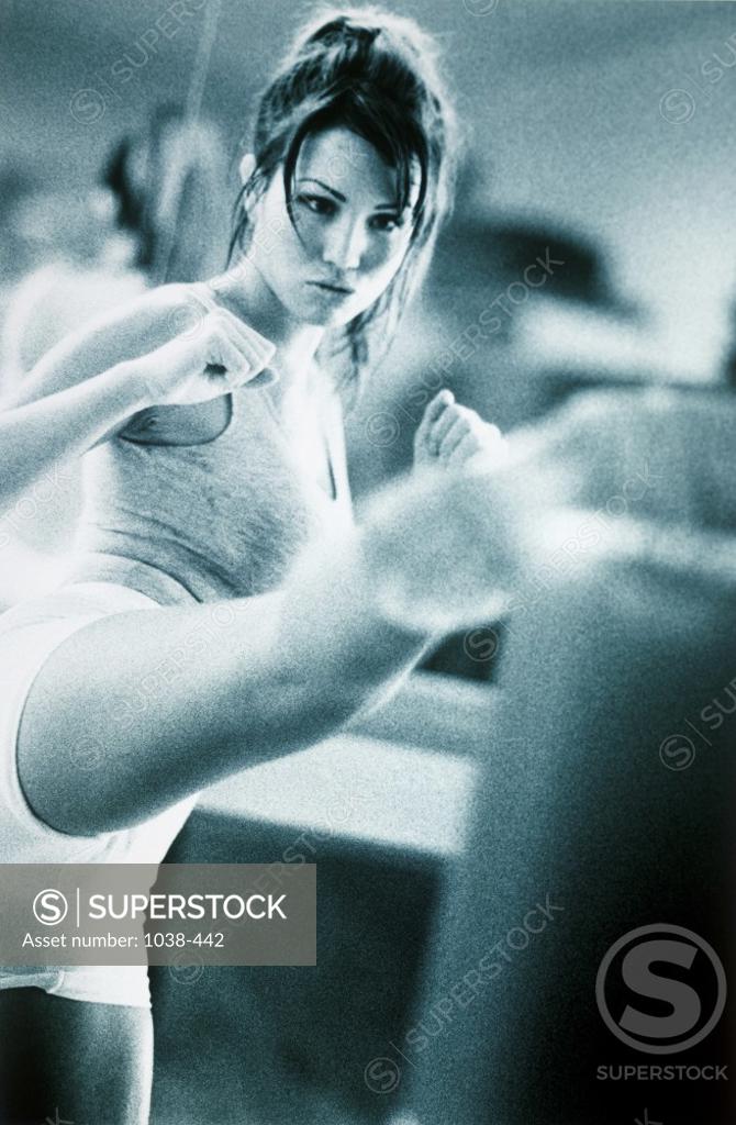 Stock Photo: 1038-442 Young woman exercising in a gym
