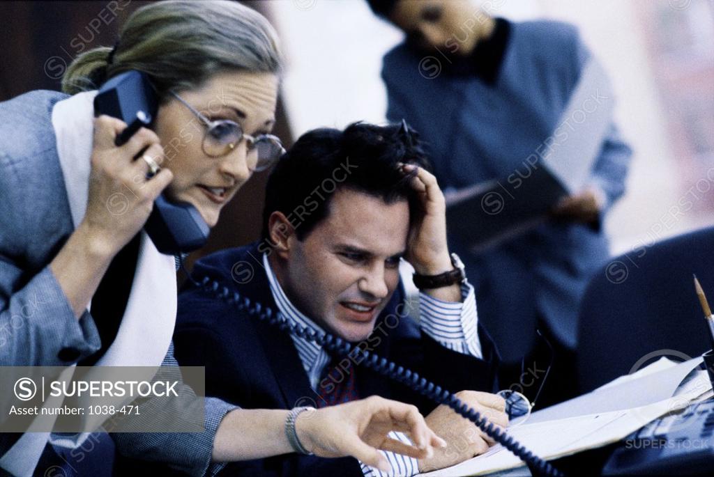 Stock Photo: 1038-471 Businessman and a businesswoman in a meeting