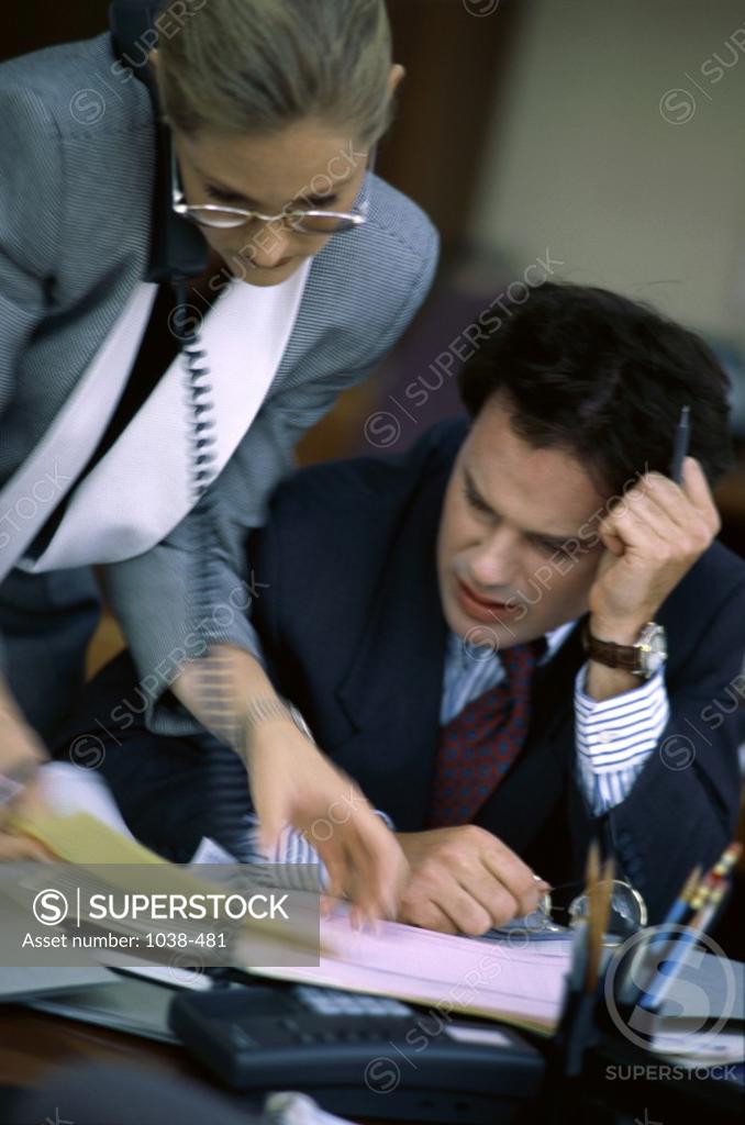 Stock Photo: 1038-481 Businesswoman and a businessman in an office