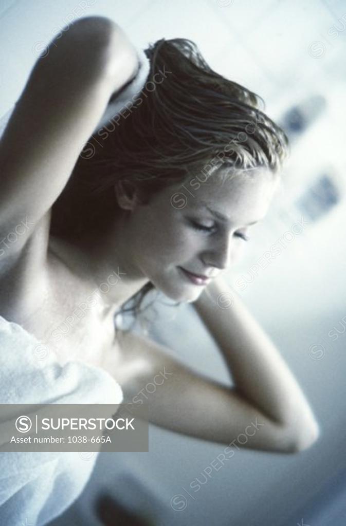 Stock Photo: 1038-665A Young woman drying her hair with a towel