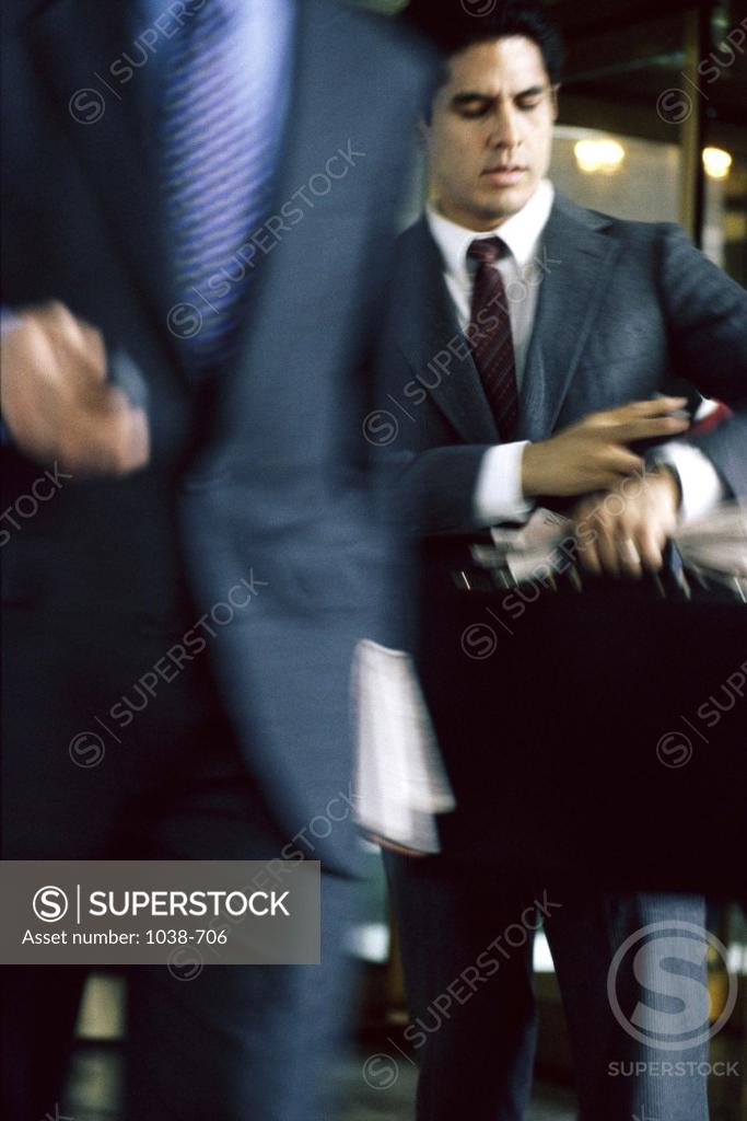 Stock Photo: 1038-706 Businessman looking at his wristwatch