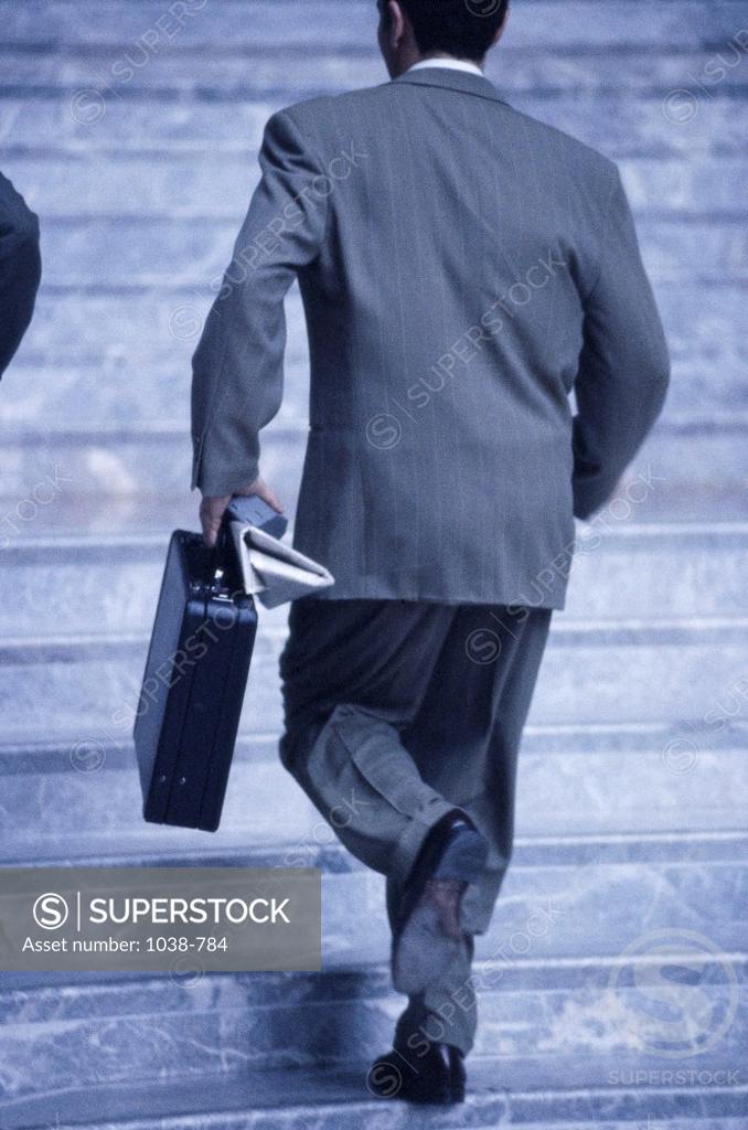 Stock Photo: 1038-784 Rear view of a businessman walking up a staircase