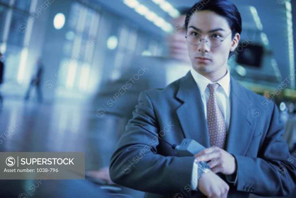 Stock Photo: 1038-796 Businessman looking at his wristwatch