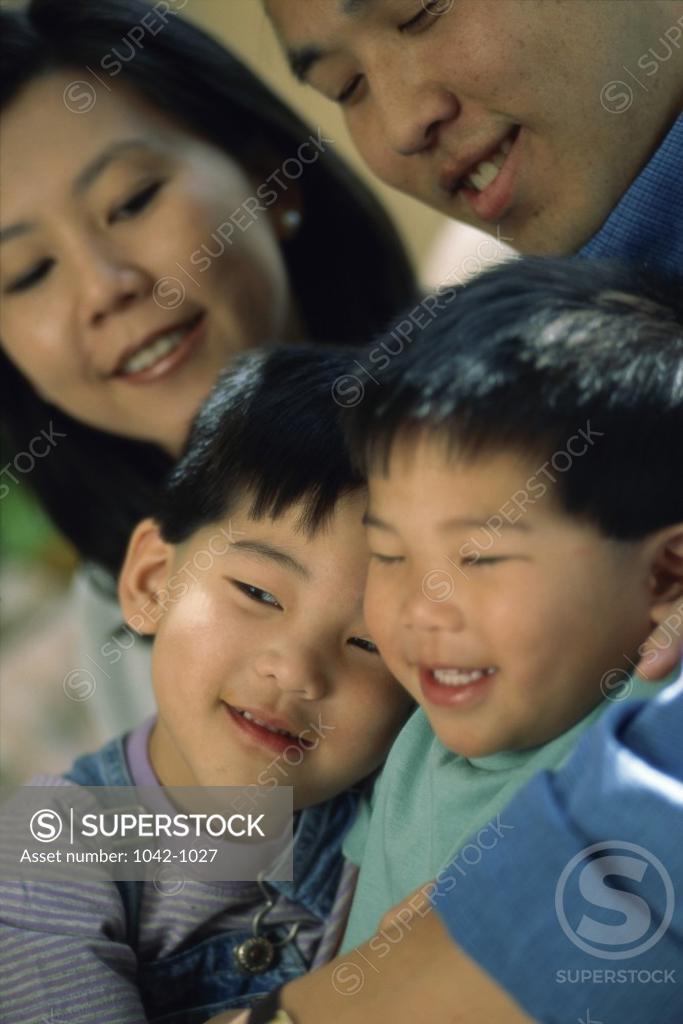 Stock Photo: 1042-1027 Close-up of parents with their two sons