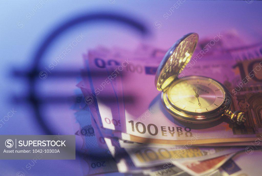 Stock Photo: 1042-10303A High angle view of euro banknotes with a pocket watch