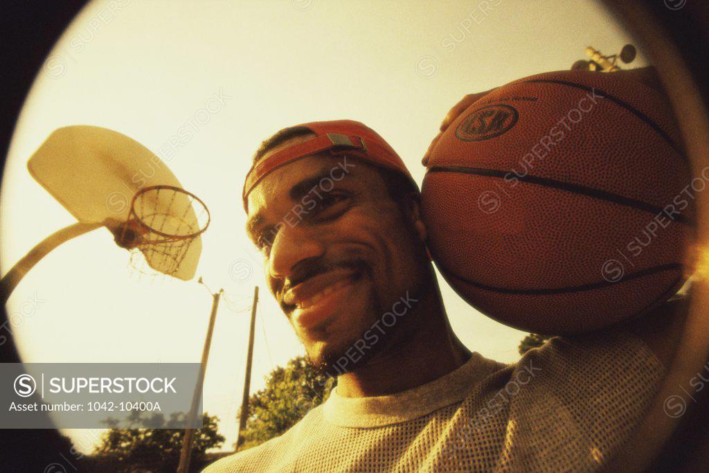 Stock Photo: 1042-10400A Close-up of a young man holding a basketball