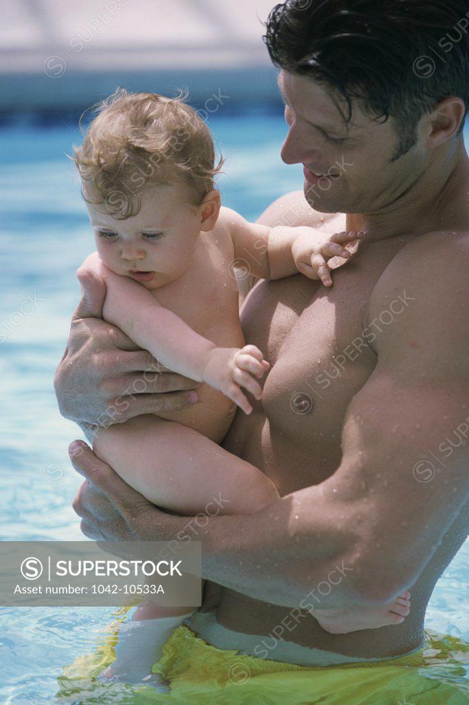 Stock Photo: 1042-10533A Father in a swimming pool with his baby boy