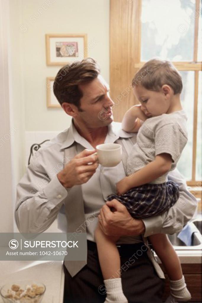 Stock Photo: 1042-10670 Father carrying his son