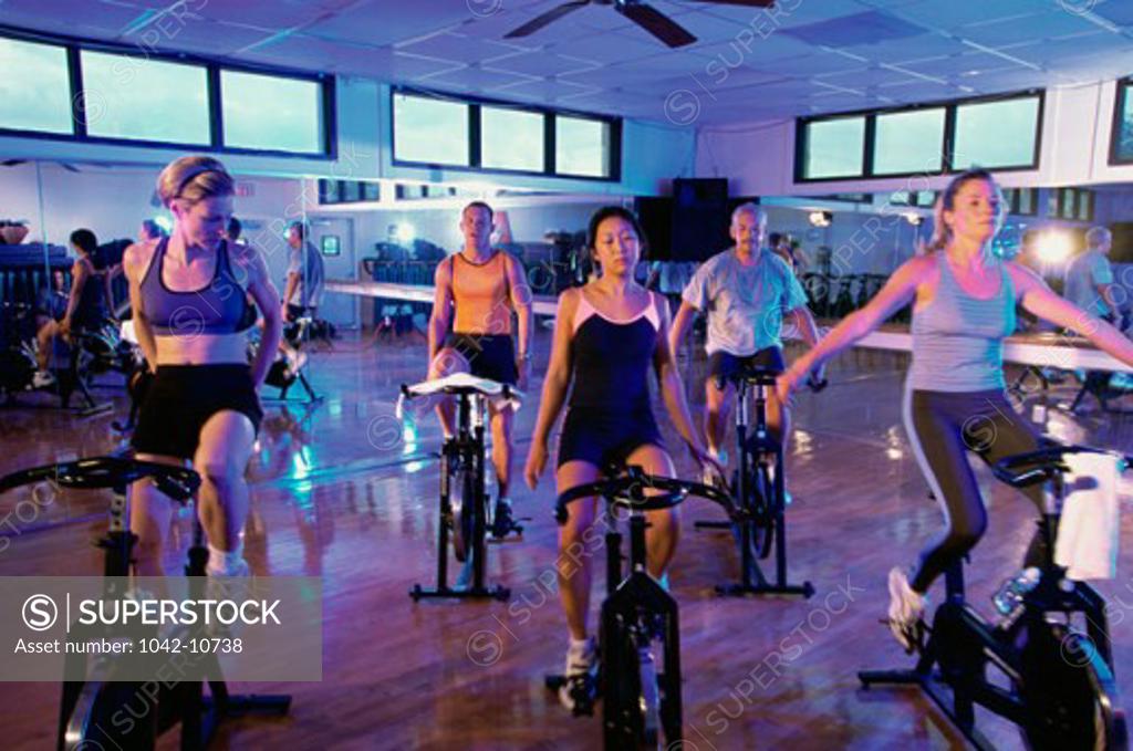 Stock Photo: 1042-10738 Group of people exercising on exercise bikes in a health club