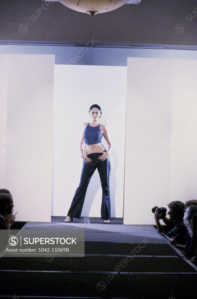 Stock Photo: 1042-11069B Portrait of a female fashion model standing on a catwalk