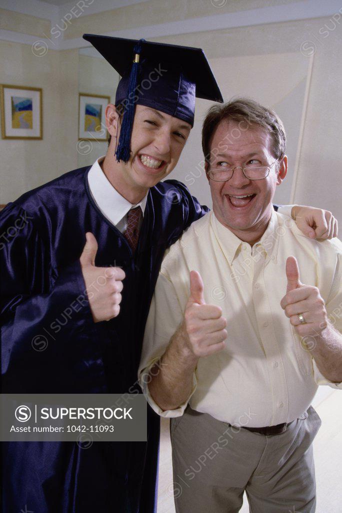Stock Photo: 1042-11093 Portrait of a young male graduate standing with his father