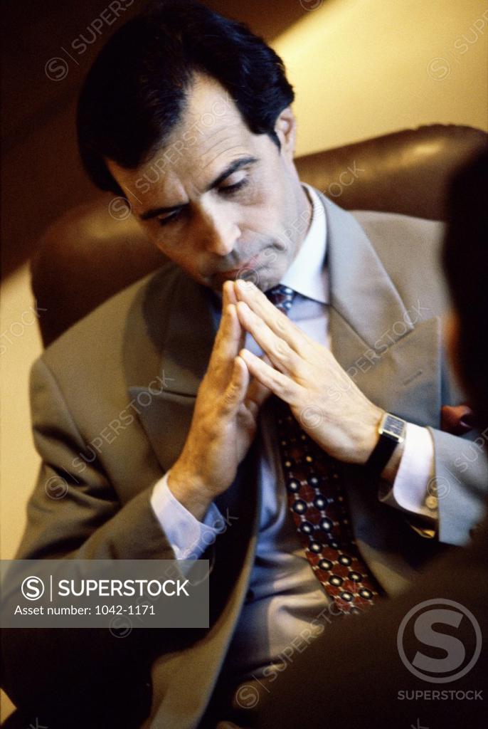 Stock Photo: 1042-1171 Businessman sitting in an office thinking