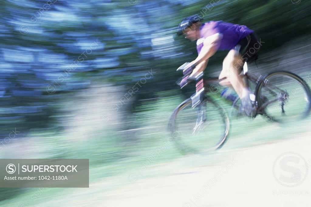 Stock Photo: 1042-1180A Side profile of a young man riding a bicycle