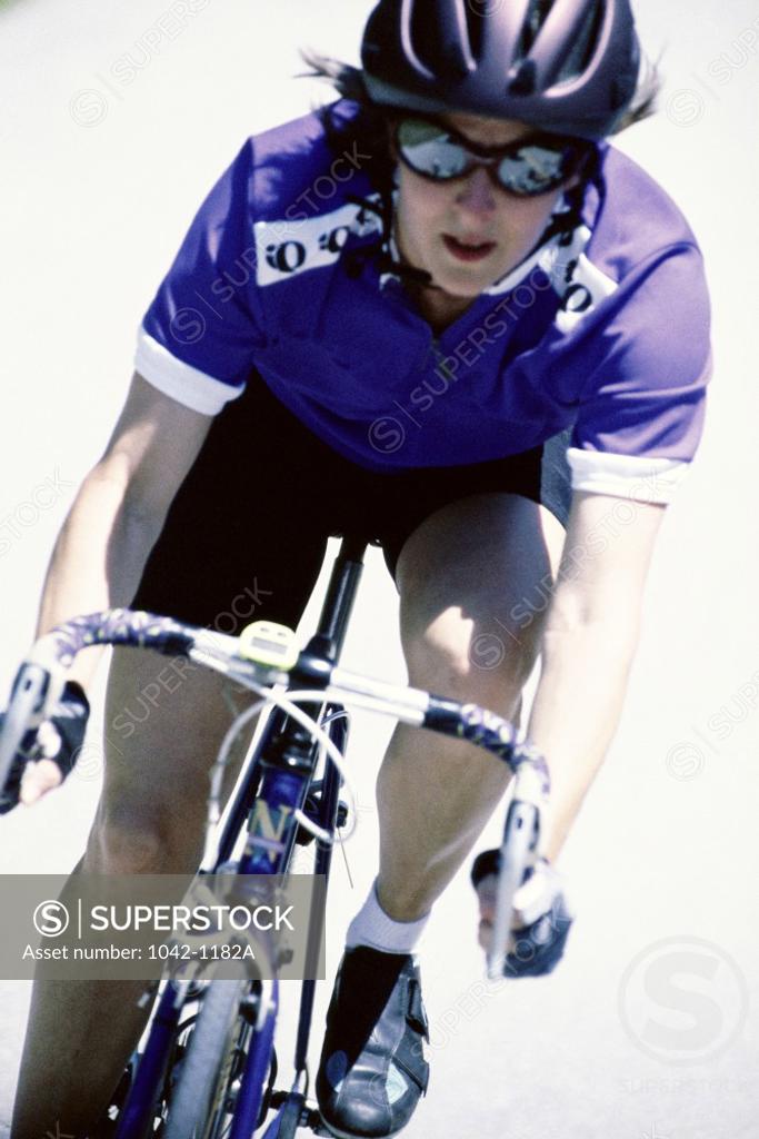 Stock Photo: 1042-1182A Young woman riding a bicycle
