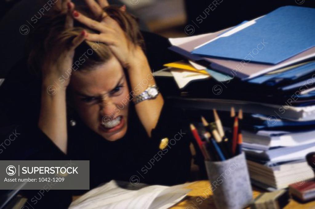 Stock Photo: 1042-1209 High angle view of a businesswoman clenching her teeth