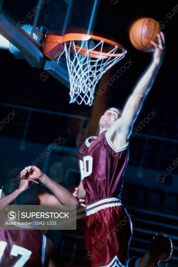 Stock Photo: 1042-1331 Basketball player slam dunking