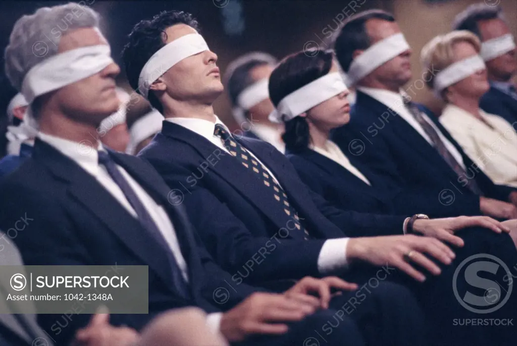 Business executives wearing blindfolds