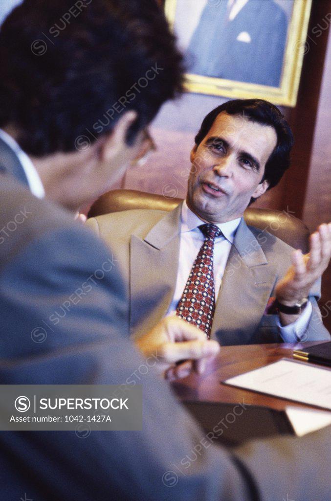 Stock Photo: 1042-1427A Two businessmen talking in an office