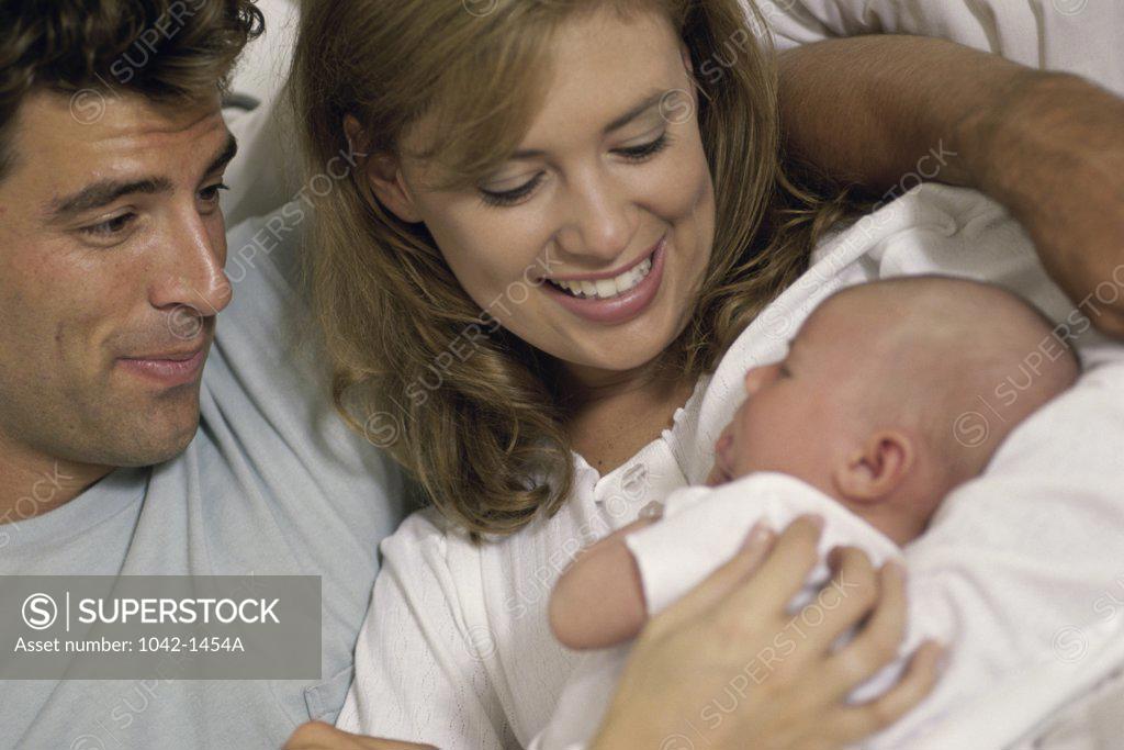 Stock Photo: 1042-1454A Parents holding their baby boy