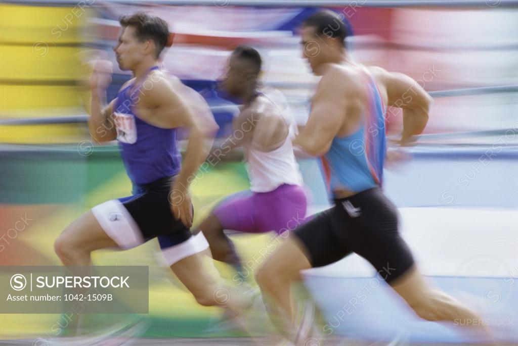 Stock Photo: 1042-1509B Side profile of three men running on a running track