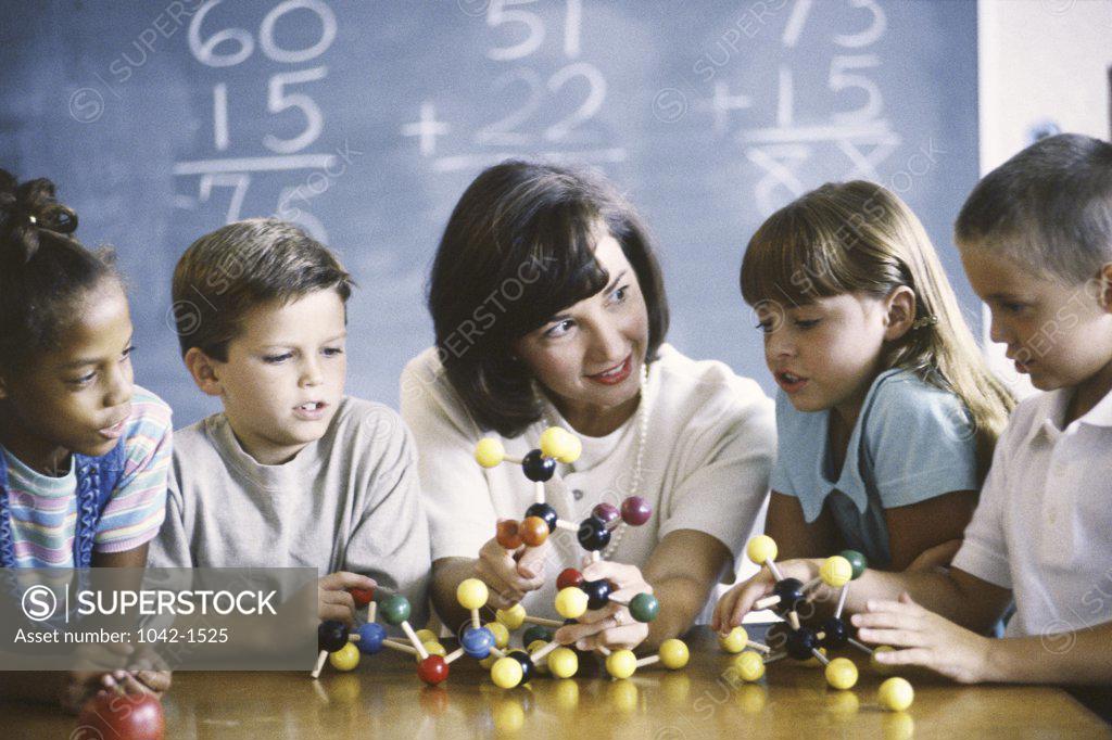 Stock Photo: 1042-1525 Teacher teaching her children about a molecular structure