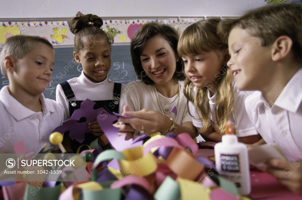 Stock Photo: 1042-1539 Students learning art and crafts with their teacher