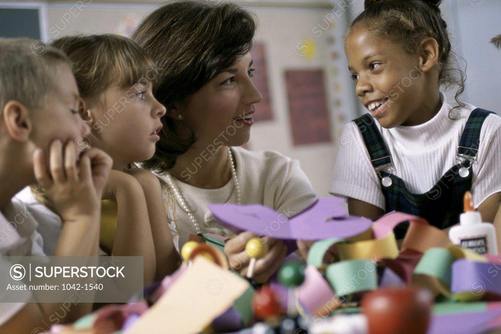 Stock Photo: 1042-1540 Students learning art and crafts with their teacher