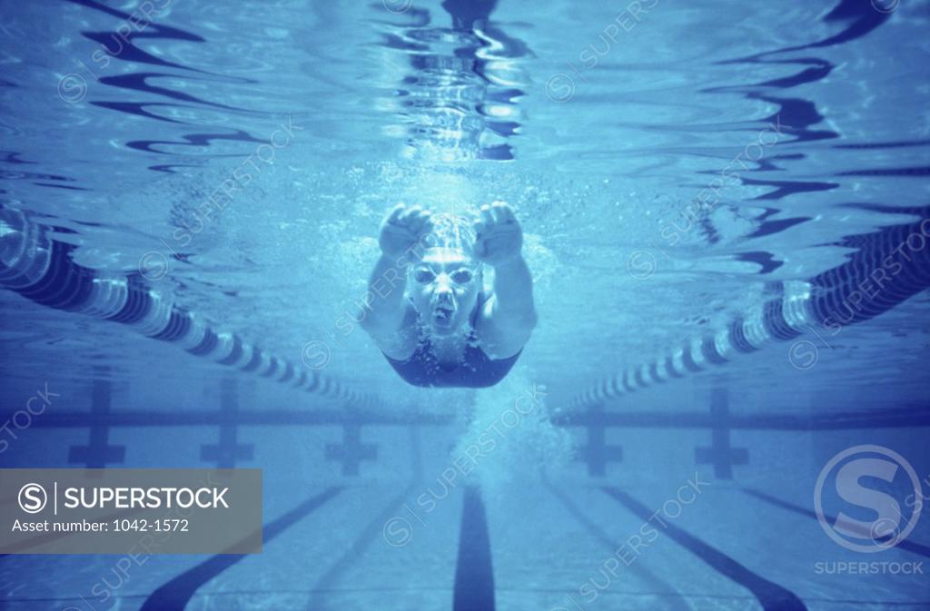 Stock Photo: 1042-1572 Young woman swimming underwater