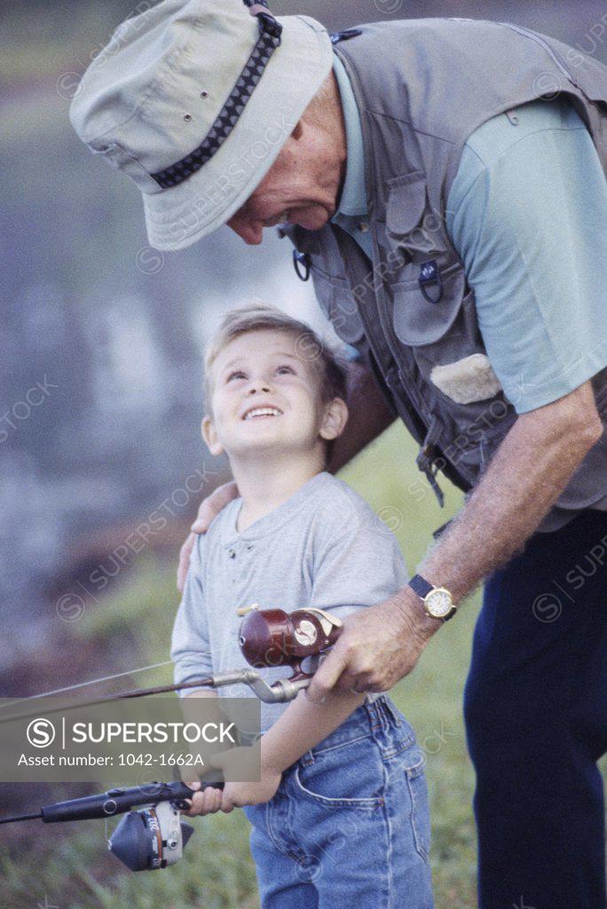 Stock Photo: 1042-1662A Grandfather and his grandson fishing