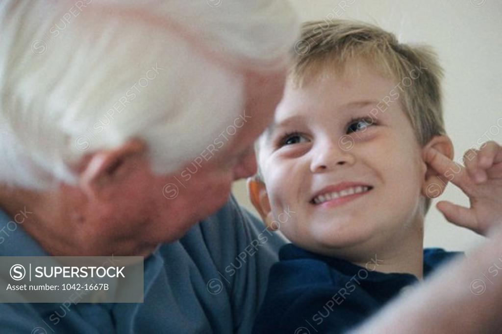 Stock Photo: 1042-1667B Grandfather and his grandson looking at each other