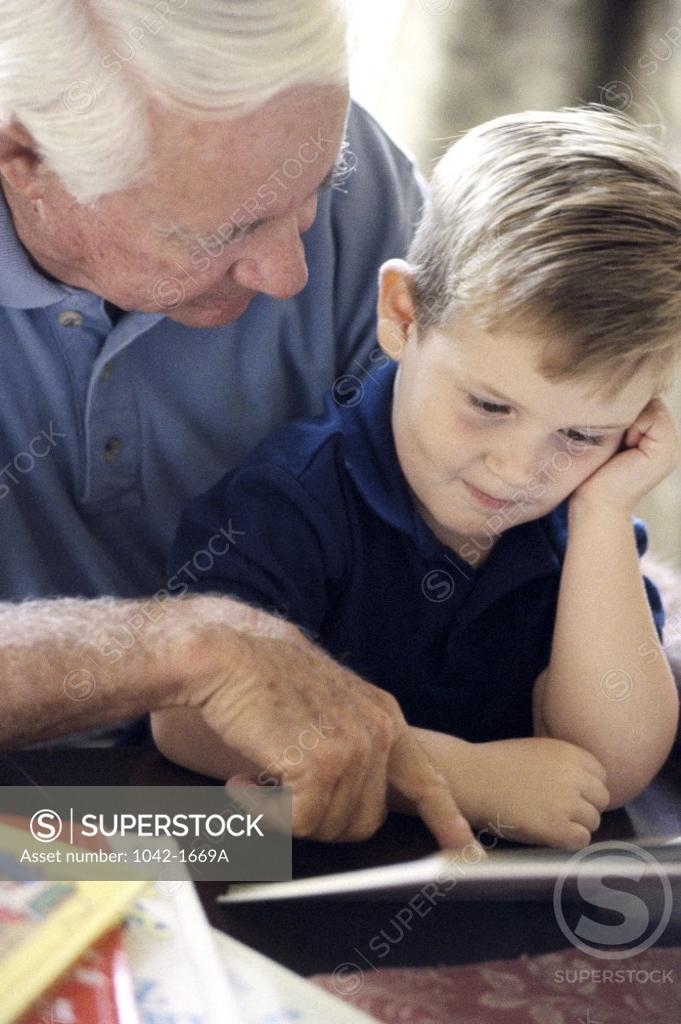 Stock Photo: 1042-1669A Grandfather teaching his grandson