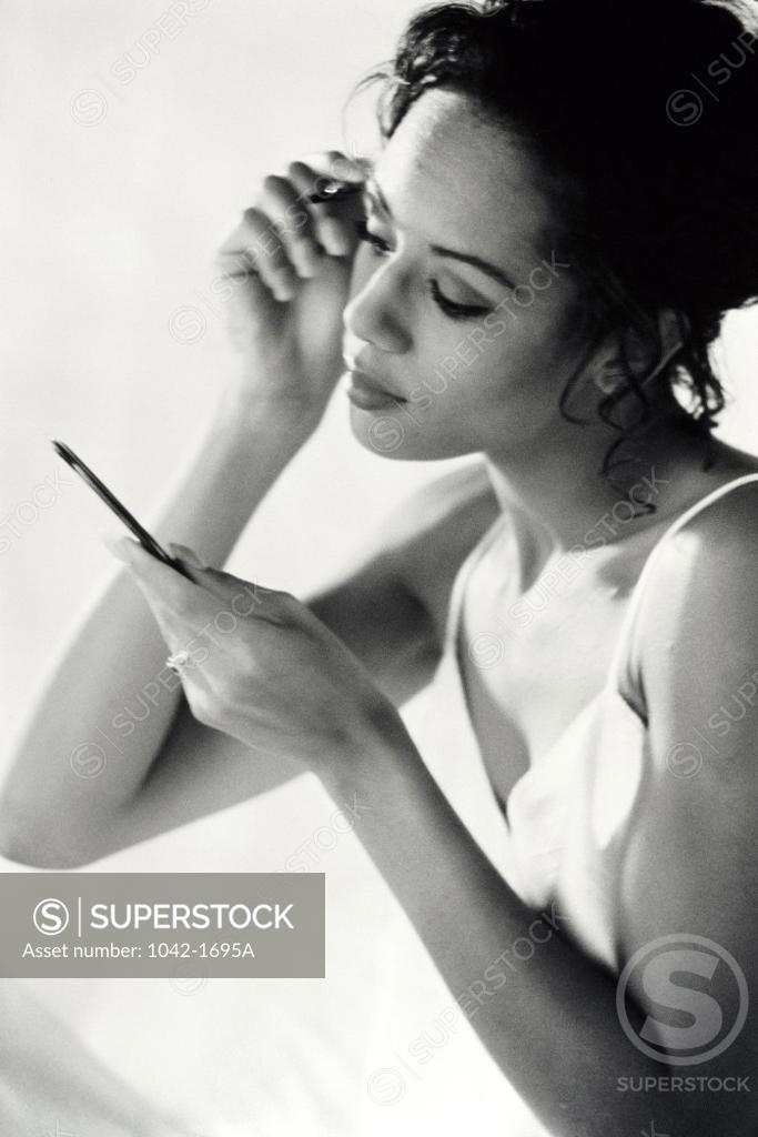 Stock Photo: 1042-1695A Young woman applying make-up
