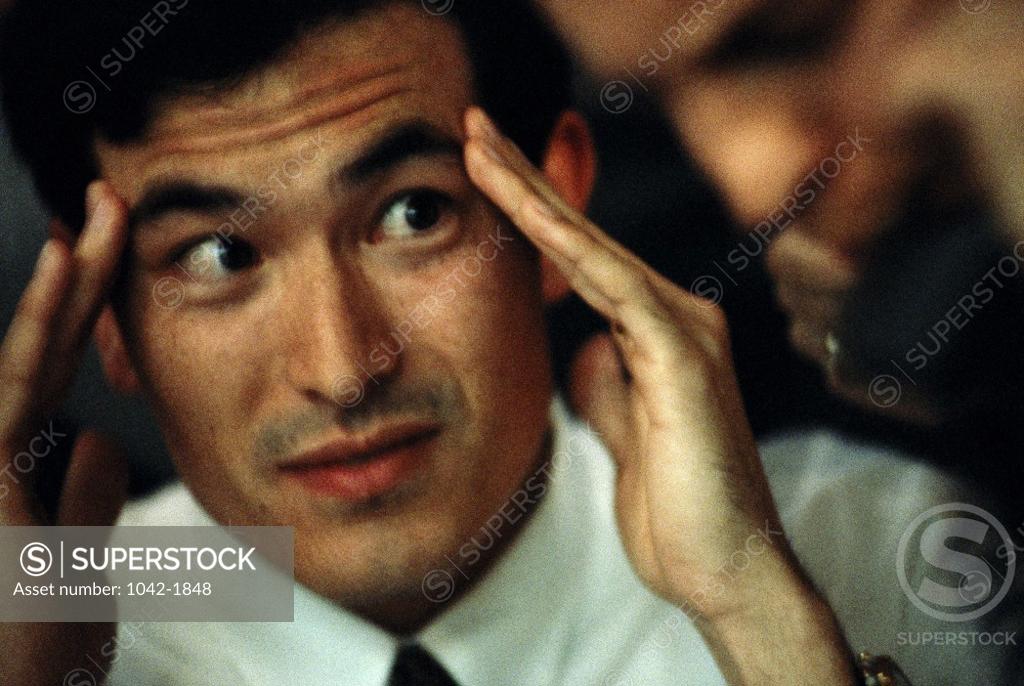 Stock Photo: 1042-1848 Close-up of a businessman holding his head