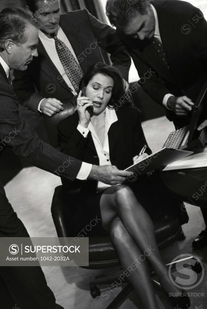 Stock Photo: 1042-2032A Three businessmen and a businesswoman in an office