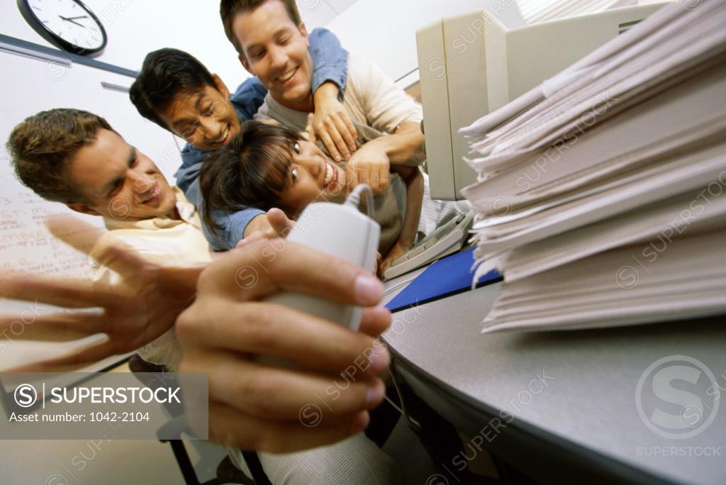 Stock Photo: 1042-2104 Group of young people reaching for a computer mouse