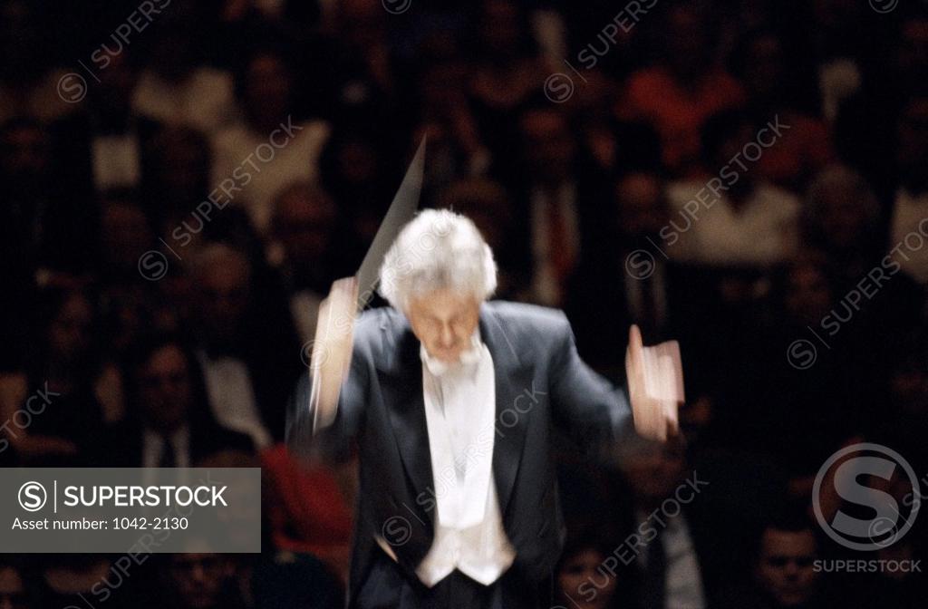 Stock Photo: 1042-2130 Conductor leading a symphony orchestra