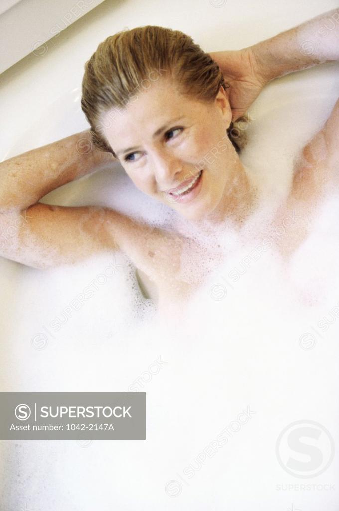 Stock Photo: 1042-2147A Mid adult woman lying in a bathtub