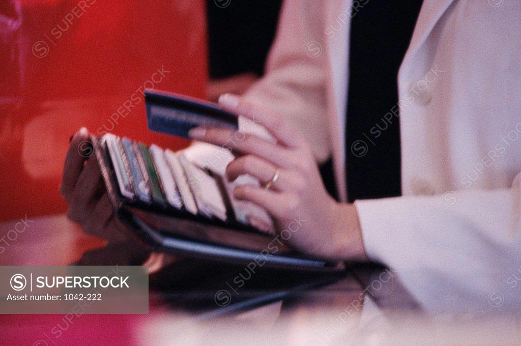 Stock Photo: 1042-222 Mid section view of a woman holding a credit card