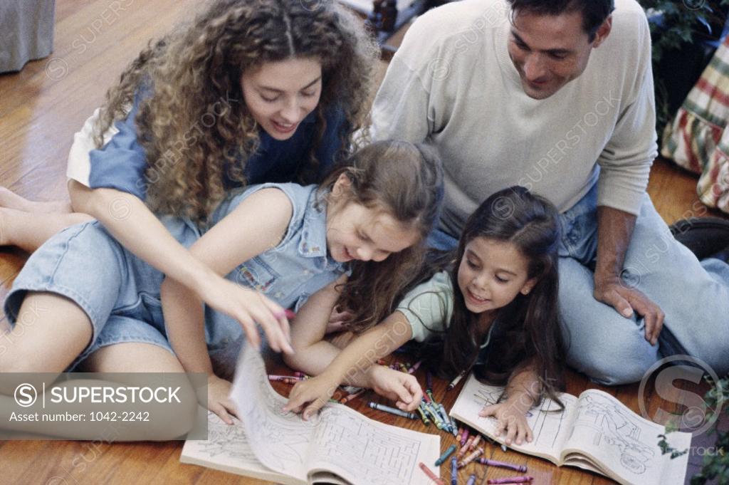 Stock Photo: 1042-2242 Parents sitting on the floor with their two daughters