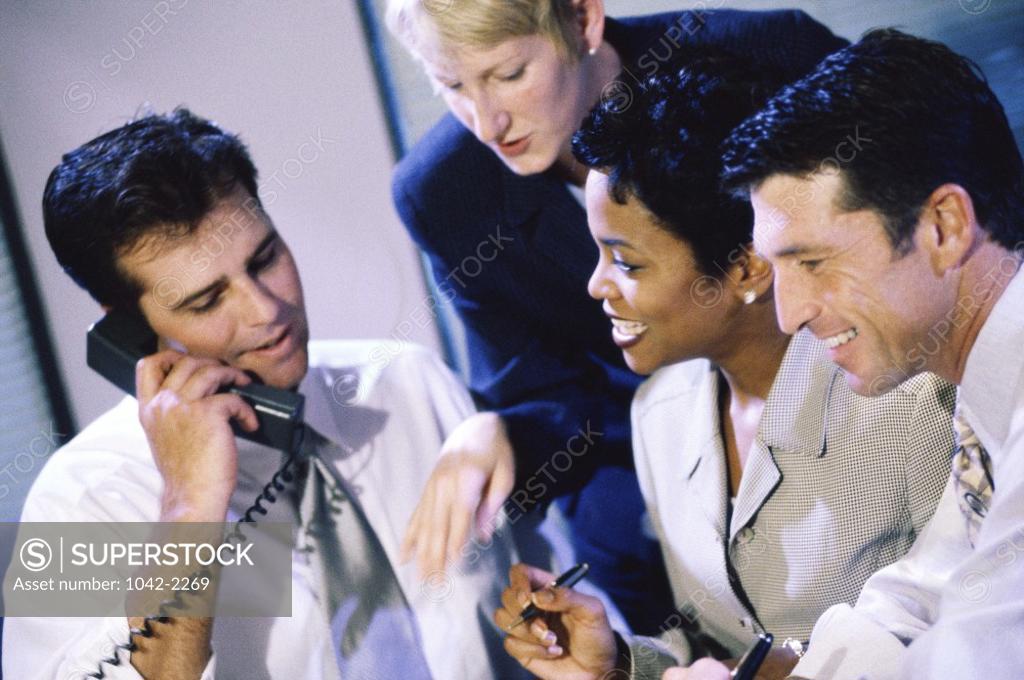 Stock Photo: 1042-2269 Two businessmen and two businesswomen in an office